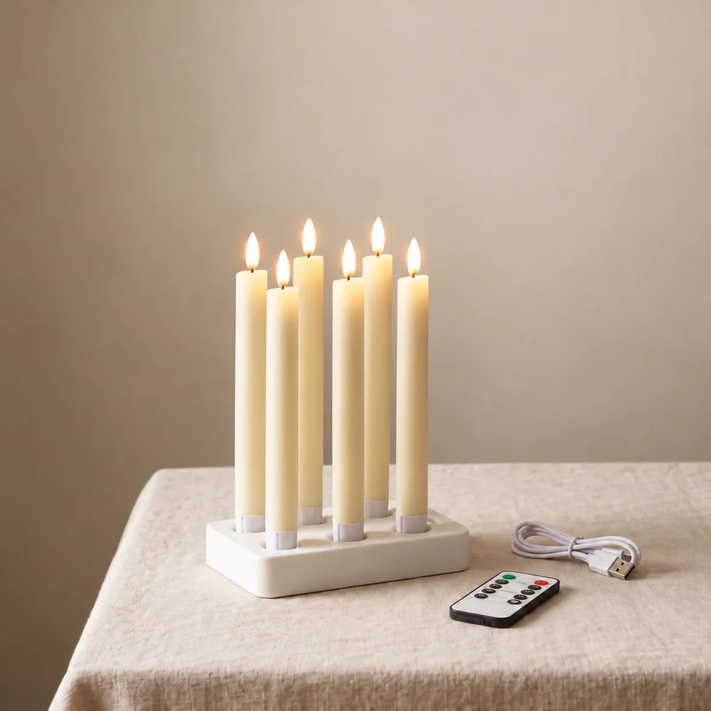 Wove Luma 1 set: 6 rechargeable LED taper candles in a white charging dock with remote and USB-C cable