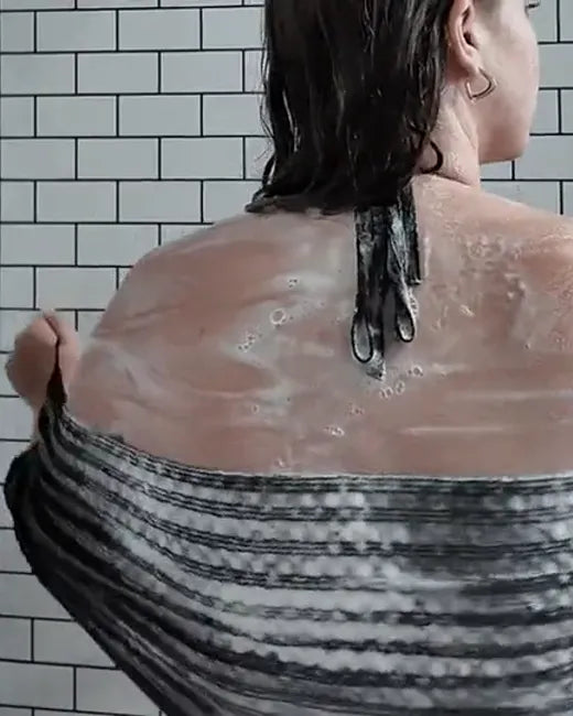 Customer showering with the Wove towel