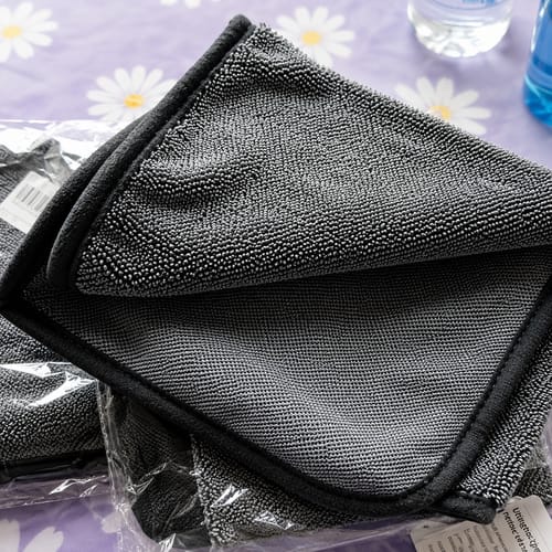 Two grey Wove microfibre cloths, one still in its packaging